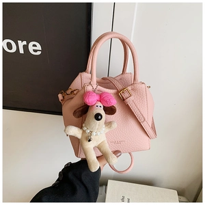 Pink lychee grain leather bag with a cute puppy plush charm and logo details