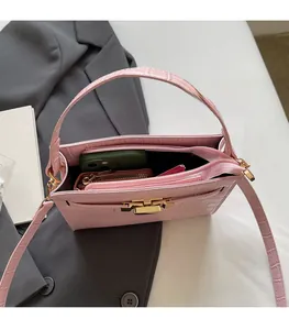 Pink crocodile pattern handbag interior capacity with golden hardware and shoulder strap