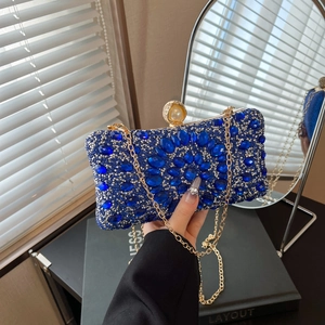 Royal blue evening clutch bag with rhinestones, pearl clasp, and gold chain strap
