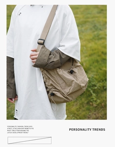 Detailed view of khaki drawstring tote bag with adjustable strap and textured nylon fabric