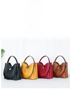 Detail of four PU leather bucket bags with snakeskin handles and gold metal buckles