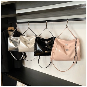 Detail view of large tote bags in silver, white, black and pink with metal buckle closures