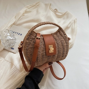 Chic woven straw crossbody bag with brown faux leather trim and golden twist lock closure