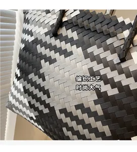 Macro shot of black, grey and white gradient woven texture on a large tote bag