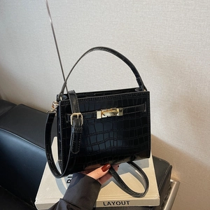 Fashionable black crocodile embossed leather handbag with gold lock and shoulder strap