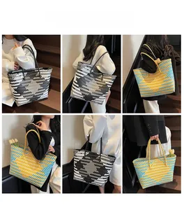 Detail view of large woven tote bag with geometric patterns and long handles