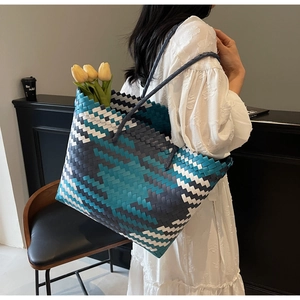 Detail of spacious handwoven tote bag featuring blue and grey geometric pattern with flowers