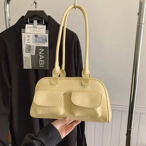 Minimalist cream yellow Boston shoulder bag with dual front pockets for commuting
