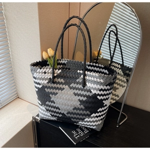 Detailed view of handmade woven tote bag in black, white, and grey geometric pattern