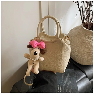 Chic beige lychee grain tote bag featuring a cute plush dog pendant and sturdy top handles