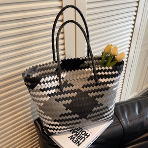 Large woven tote bag with geometric tricolor pattern and round handles for beach or shopping