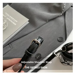 Detail of adjustable black snake skin texture leather strap with silver metal buckle