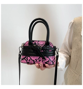 Detail of pink and black snakeskin pattern on a mini shell-shaped crossbody bag