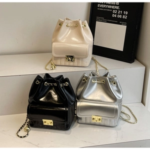 Mini high-gloss drawstring backpacks in beige, black and silver with chain straps