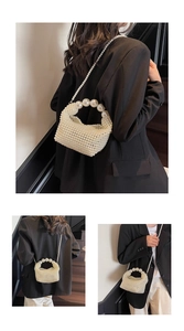 Detail of handmade pearl beaded handbag featuring large round pearl handle and fine texture