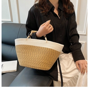 Detail of a woven tote bag with wooden bead handle and khaki white contrast panels