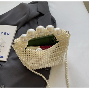 Detail of handmade pearl woven mini bag showing capacity for phone and cosmetics