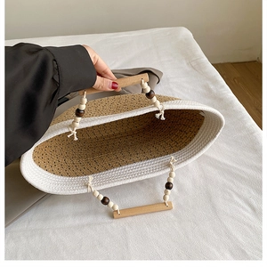 Top view of woven tote bag showing spacious interior and natural wood bead handles