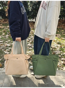 Detailansicht großer Canvas-Tragetaschen mit seitlichem Kordelzug in Beige und Olivgrün