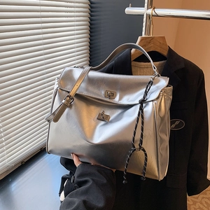 Silver metallic large tote bag with double twist locks and woven knot pendant