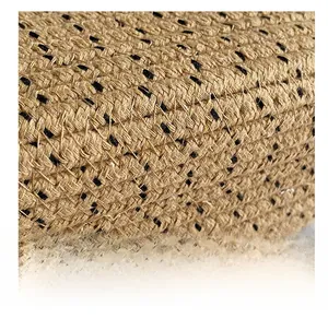 Macro detail of the woven tote bag featuring straw material with black polka dot patterns