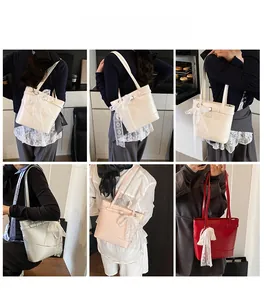 Detail of trendy bucket tote bag featuring a delicate white lace bow ribbon and metal buckle