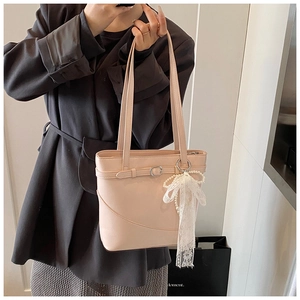 Detail of light pink PU leather bucket bag with lace pearl bow pendant and buckle