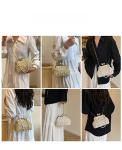 Detail showing the straw woven clutch bag with pearl accents and versatile chain straps