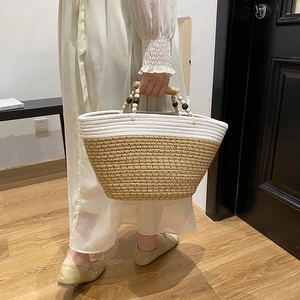 Woven tote bag with wooden handles and bicolor bohemian design for casual beach style