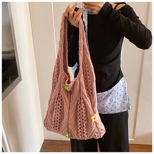 Detailed close-up of pink hollow knit tote bag with 3D colorful floral accents
