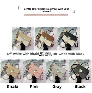 Detail view of contrast flap handbag featuring textured faux leather and shield metal lock