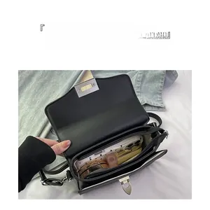 Internal view of the black leather bag showing large capacity and organized compartments