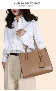 Detail of khaki tote bag featuring geometric patterns and premium faux leather handles