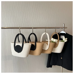 Collection of four stylish woven tote bags in monochrome and brown colorways on hangers