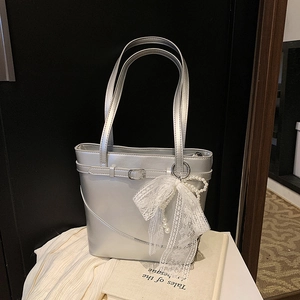 Silver metallic bucket tote bag with large white lace bow and pearl pendant charm