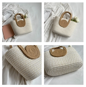 Close-up of woven straw handbag texture featuring gold glitter thread and rope handles
