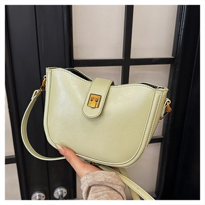 Nahaufnahme der hellgrünen Vintage-Eimertasche aus glänzendem Leder mit Goldschnalle