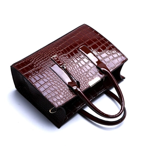 Classic burgundy crocodile pattern tote bag with polished finish and gold metal hardware