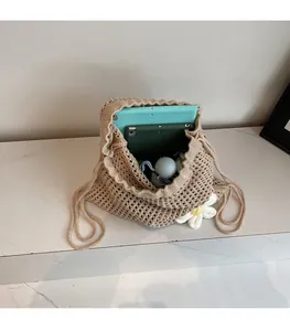 Macro detail of spacious interior in a beige hollow crochet bag with two tablets inside