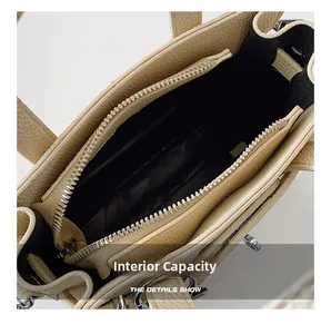 Detail view of the bag's black interior lining with a zipper pocket and metal closure