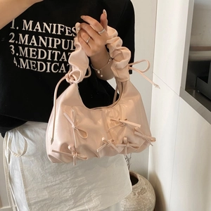 Pink pleated cloud bag with bow accents and top handle for women in balletcore style
