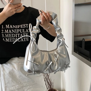 Silver metallic ruched shoulder bag with bow details shown in a mirror selfie view