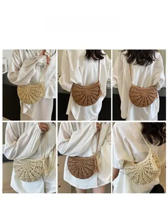 Detail view of woven straw shoulder bag with radial cut-out patterns and tassel decor