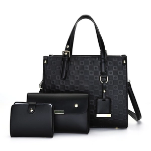 Three-piece black geometric tote bag set with matching clutch and compact wallet