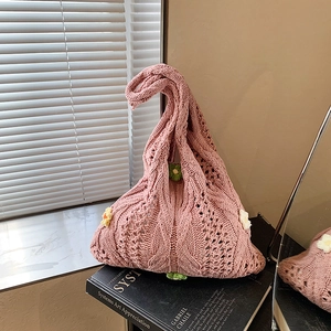 Pink woven knit shoulder bag with hollow texture and handmade 3D floral accents