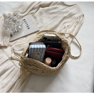 Internal view of beige woven beach bag showing spacious capacity and zipper closure