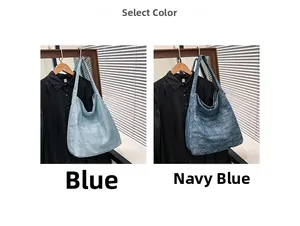 Detail view of large canvas tote bags in blue and navy with textured fabric material