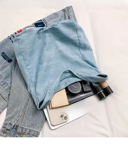 Detailed interior of a light blue rhinestone denim tote showing large capacity storage