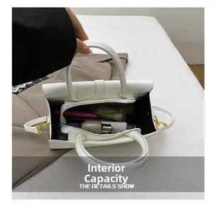 Internal capacity of white wave pattern tote bag showing cosmetics and lipsticks
