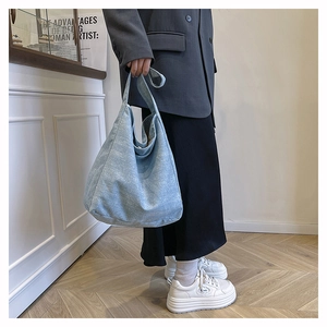 Detail of light blue vintage canvas tote bag with white spot texture and spacious design